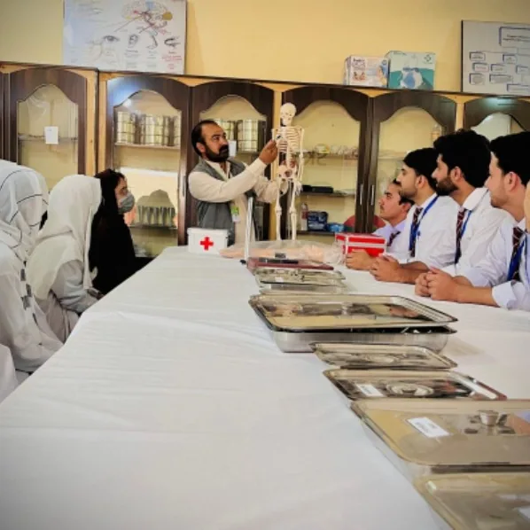 An instructor demonstrating on a skeleton to nursing students