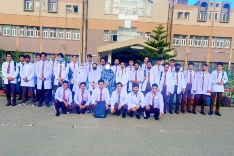 BS Nursing students in clinical coats outside the College
