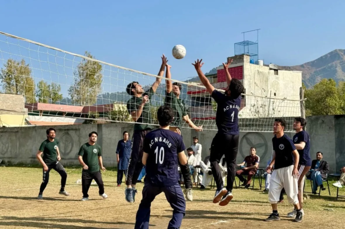 Students playing volleyball on the College ground